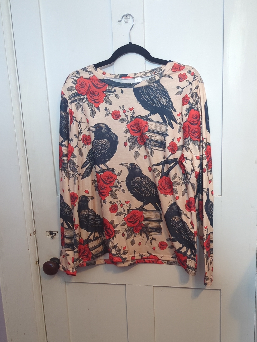 Long sleeve crow/roses/book print top. Never worn.